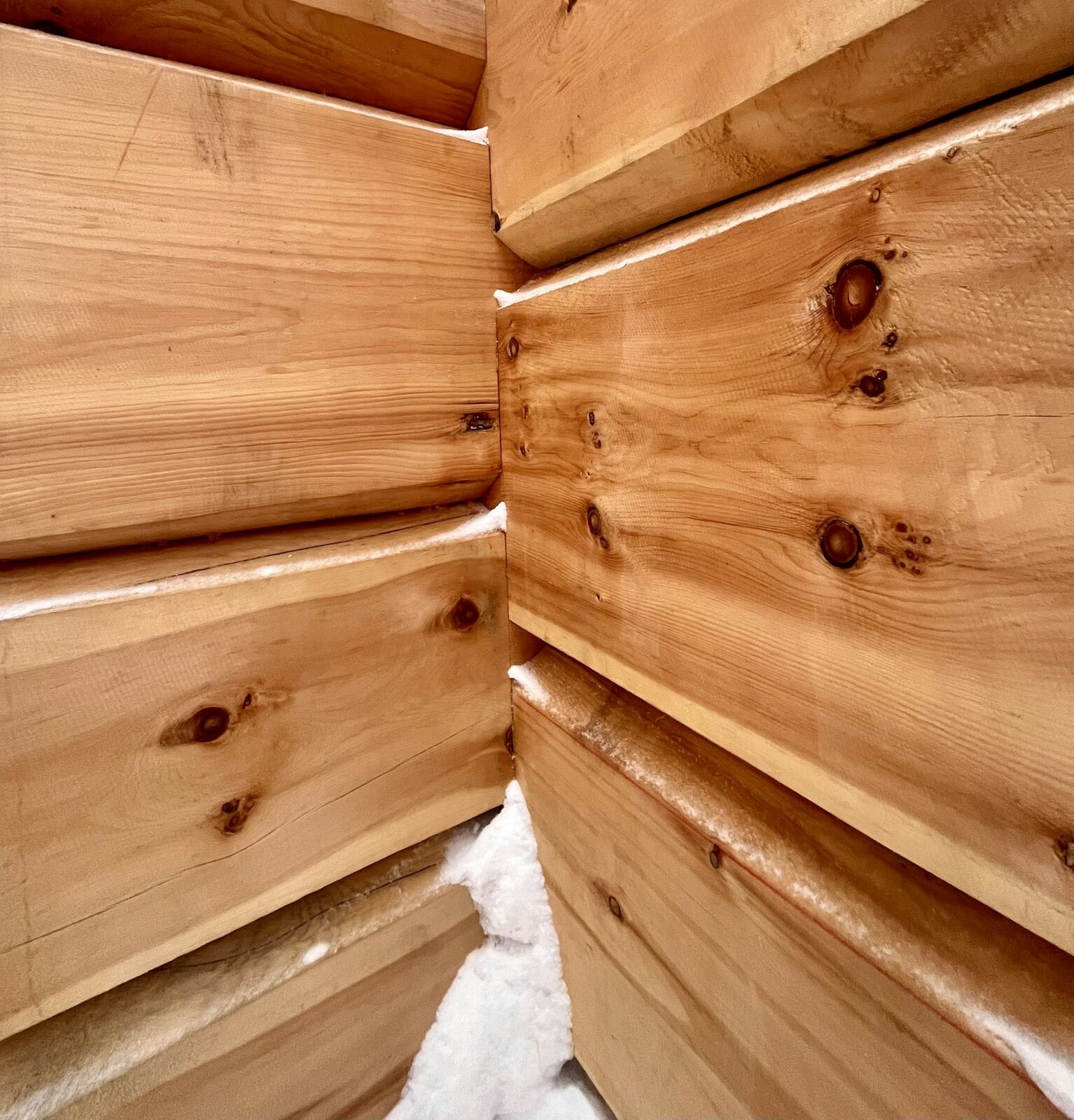 Stacked cedar planks with visible knots and grain